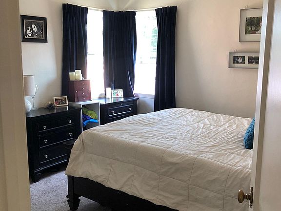 Bedroom, large closet, ceiling fan, two windows.