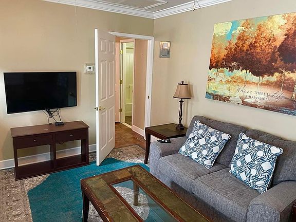 Living area with nearly new love seat and 43" flat screen TV.