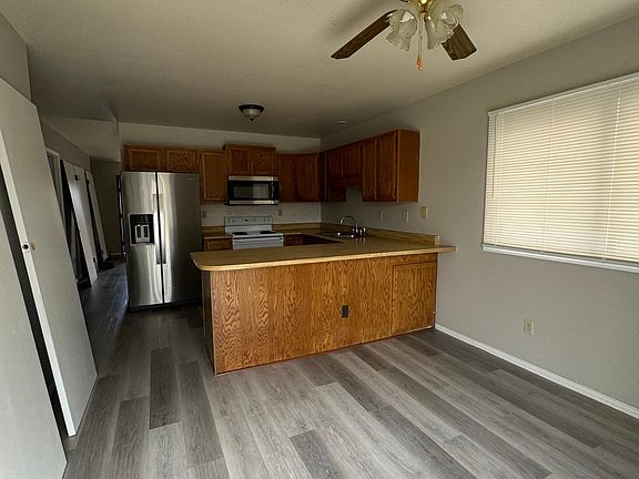 Dining and kitchen area with new laminate flooring and fresh paint