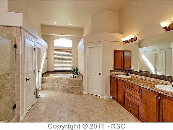 master bathroom includes deep sunken tub and fireplace