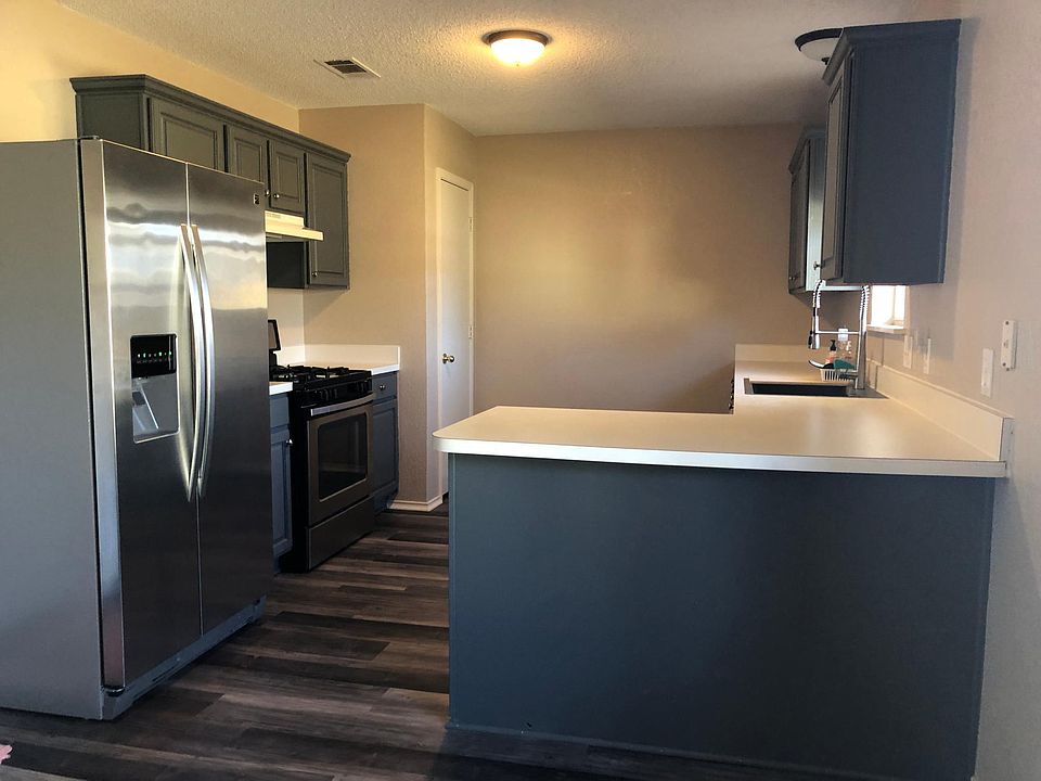 Kitchen, stainless appliances, the vent hood has been replaced with a microwave over the stove.
