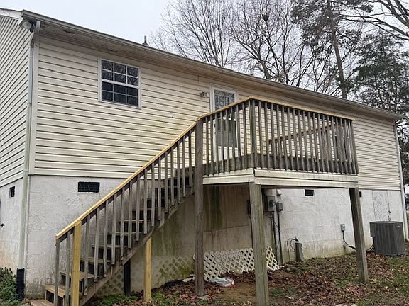 Rear of house
Deck stairs. 
Access to crawl behind HVAC unit