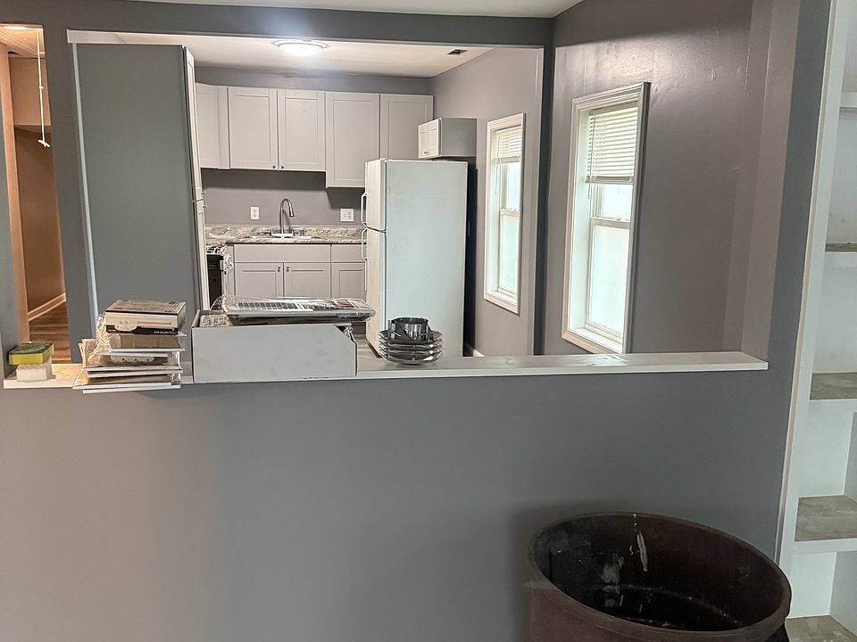 END OF LIVING ROOM LOOKING INTO DINING AREA AND KITCHEN