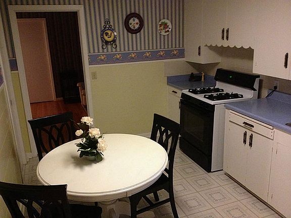 Country kitchen has room for breakfast table.