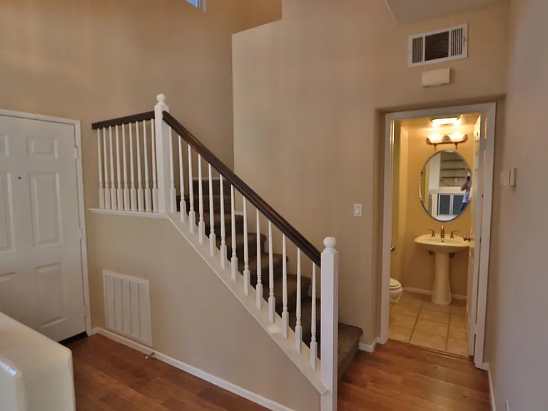 Front door, powder rooms and stairs to four bedrooms upstairs
