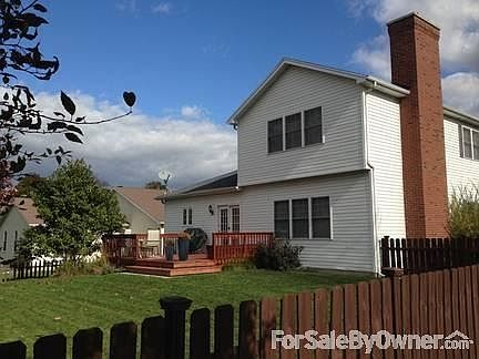 Fenced in back yard with deck