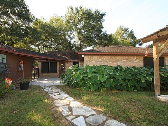 Here s the Back of the Home with a connected patio and lovely stone path that leads to the pergola.