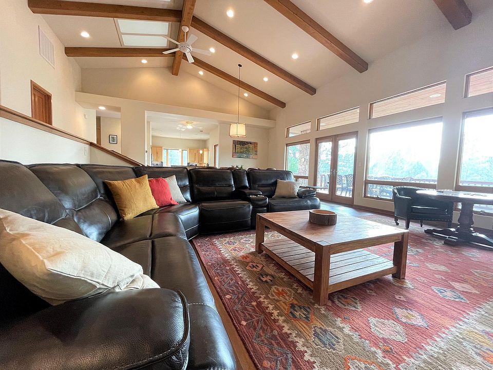 Large high-end sectional sofa with three reclining seats. Four seat game table to the right in the photo