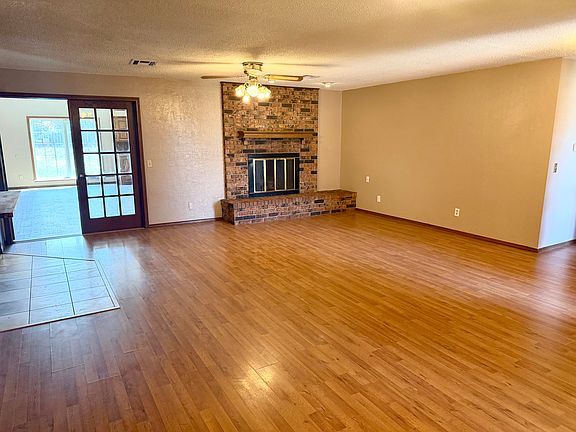Main Living Area with wood burning fireplace, wood like flooring.