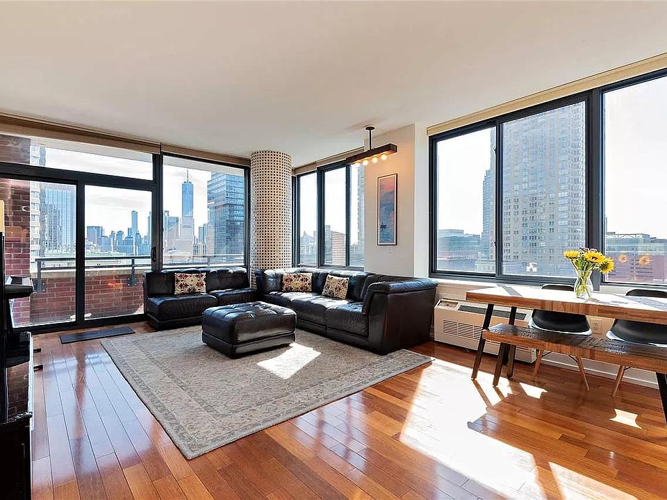 Living room: South and East exposure with views of Manhattan and Hudson river!