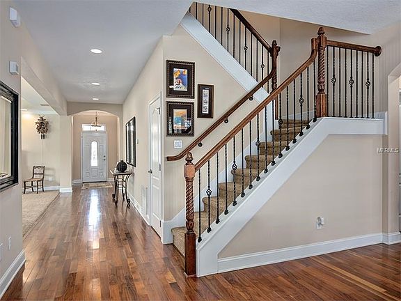 Foyer and Custom iron work stairs to 2nd floor bedrooms and bonus room.
