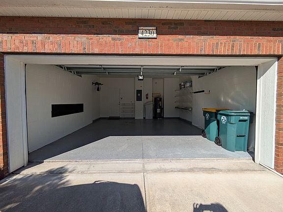 Spacious 2 Car Garage with Epoxy flooring and storage racks.