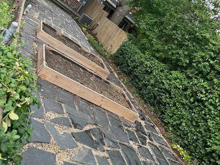 Fully fenced back yard with raised garden beds, slate and pebble hardscape. Two off street parking spaces included.