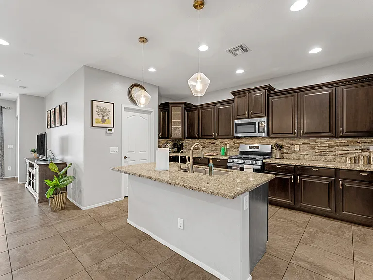 Kitchen with walk-in pantry. Island faces the dining and living room so you can still visit while washing dishes and preparing food.