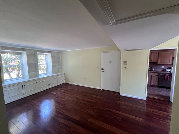 Living Room w/ built ins; entry