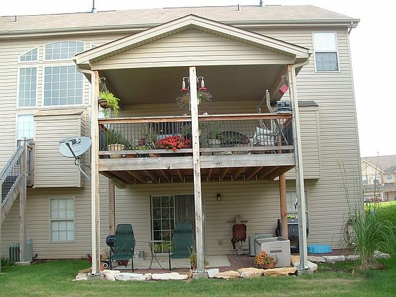covered deck with view of private garden treelined common ground