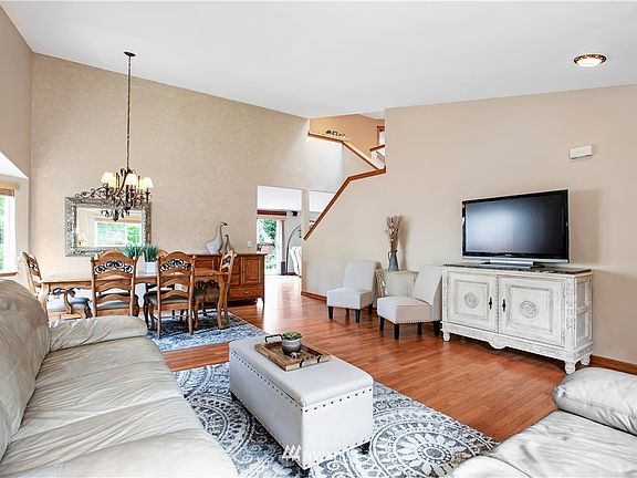 Enter to this Living/Dining area with Vaulted Ceiling and hardwood flooring