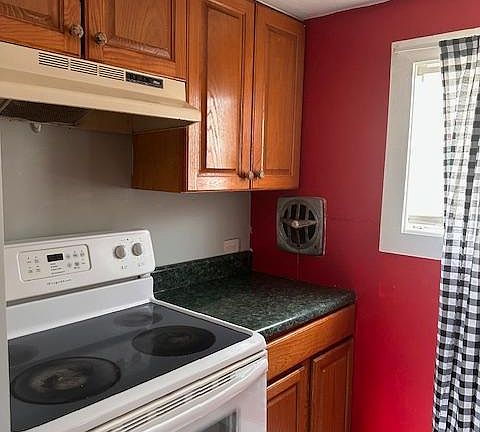 Kitchen with stove and refrigerator.