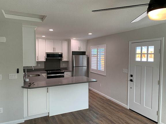 Large kitchen with stainless steel appliances, ample cabinet space, microwave over oven, and island built for seating 2-3