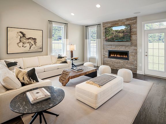 The great room is the perfect setting for relaxation with a cozy fireplace and ample natural light