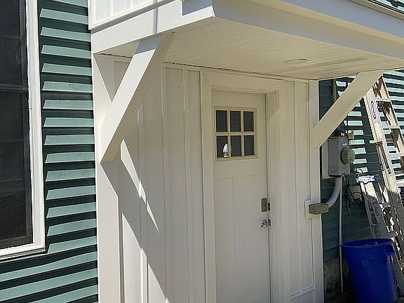 Side door with overhang roof