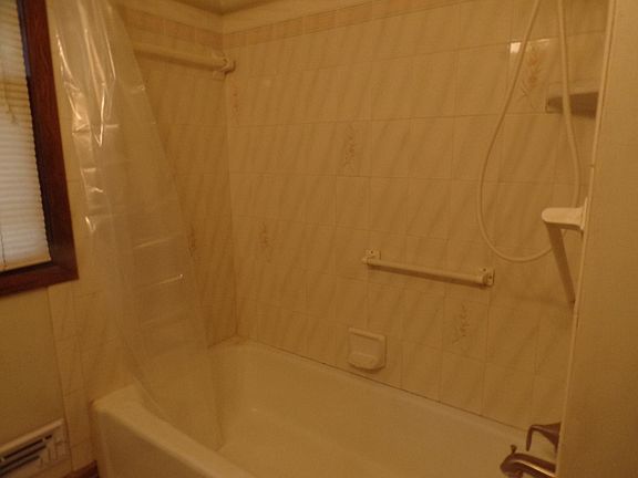 Upper level bathroom with full tub and shower
