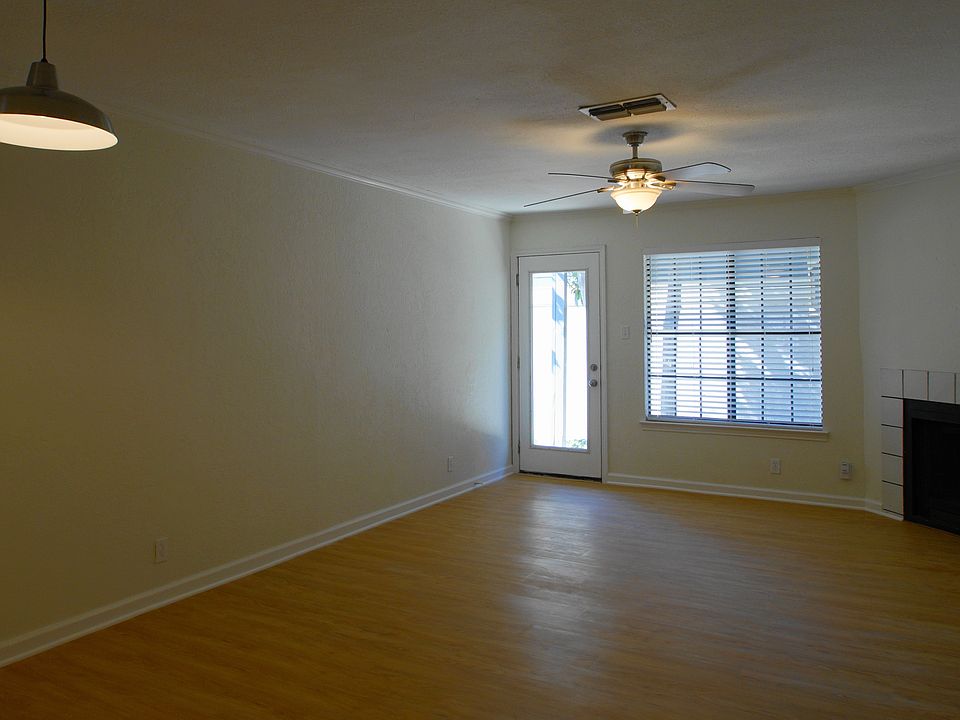 Living room with wood burning fireplace and new flooring.