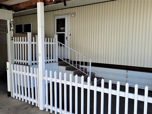 Large covered patio area, fenced with access to porch and elevator>