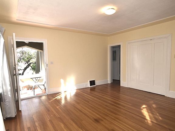 Living room towards hall in evening light with partial view of front porch July '20
