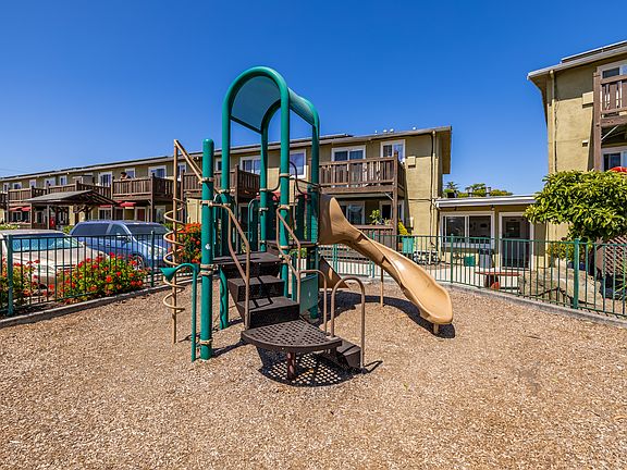 On-site playground with climbing features and a slide, offering a safe and fun space for children to play and explore.