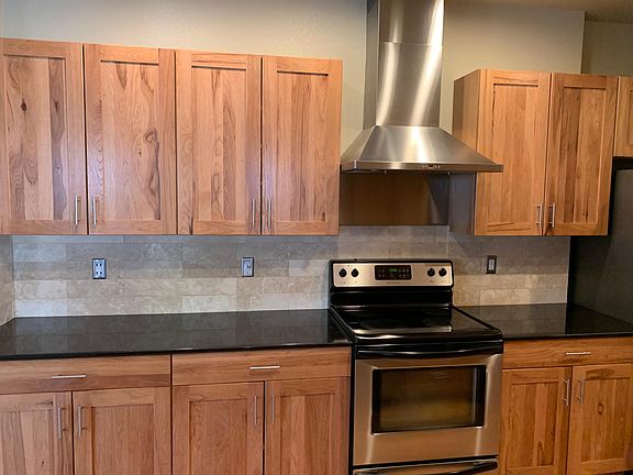 Stainless steel hood vented to the outside. Glass top electric range. Travertine backsplash. Granite countertops. Bosch refrigerator/ freezer. Frigidaire dishwasher.