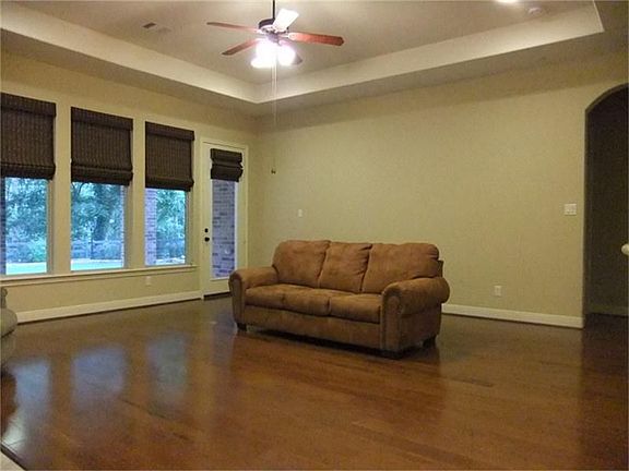 Den is a wonderful space that opens to the kitchen and offers fantastic views of the wooded area behind home.