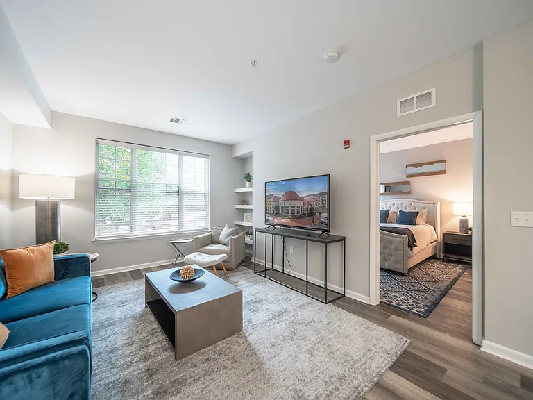 a spacious living room with a large window at Harbor Pointe, Bayonne, New Jersey