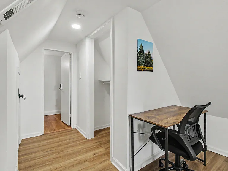 Compact bonus nook with a built-in closet and dedicated desk areaideal for a home office or extra storage.