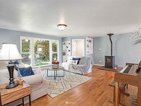 Floor to ceiling windows fill the spacious living room with natural light.>