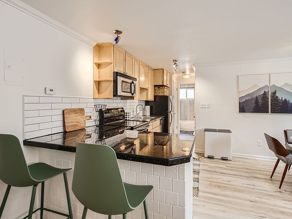 The kitchen features bar seating, granite countertops, modern subway tile backsplash, stainless steel appliances, & all the kitchen tools needed for your extended stay. Also included, is various cleaning supplies & a full-sized pantry for storage.