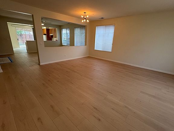 View from living room to dinning room, kitchen and backyard area.
