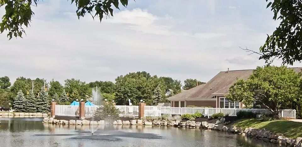 Tranquil pond with pool and clubhouse view