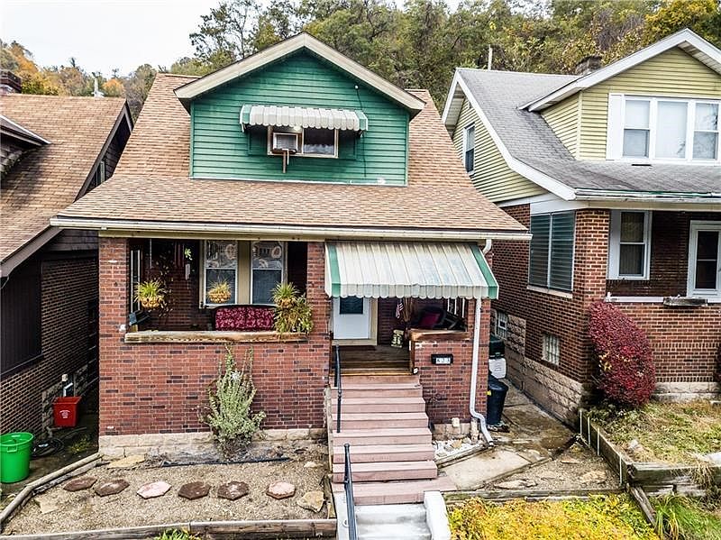 Craftsman style brick home with charming front porch.