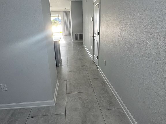 Hallway Entry _ Bright hallway with tiled floors and a clean, open feel leading to the living areas.