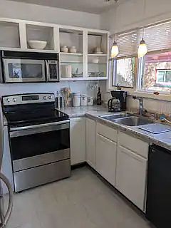 Kitchen with stainless steel appliances. Comes complete with dishes, cookware, utensils, etc