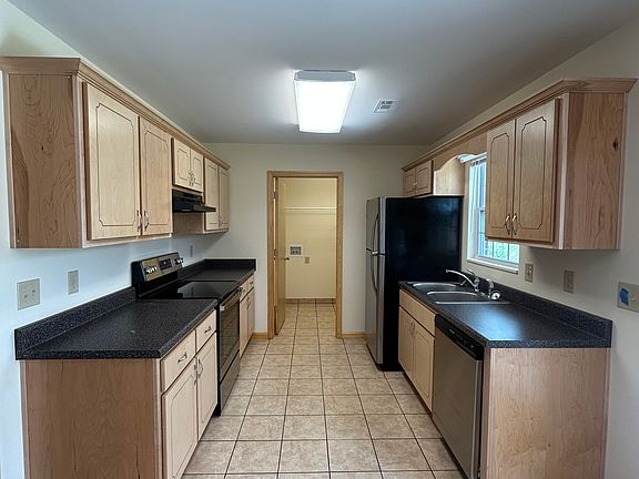 Galley kitchen and entrance to laundry room.