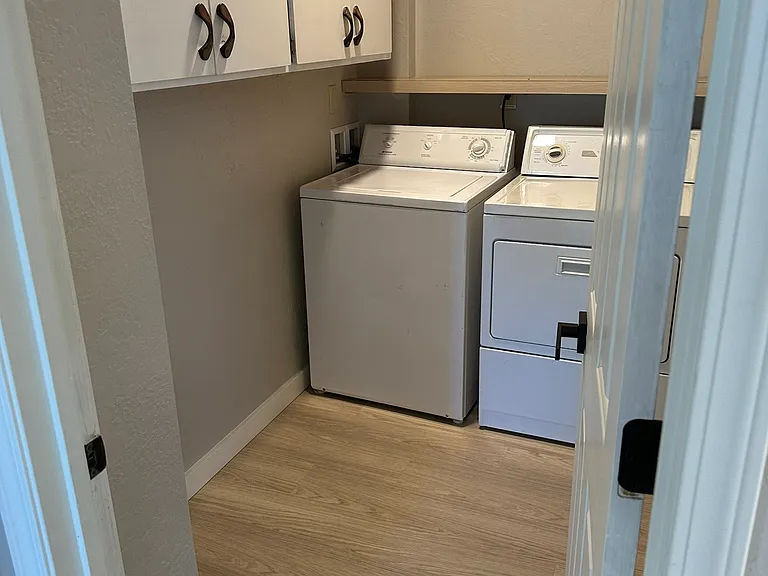 Large Laundry room with lots of storage, washer and dryer