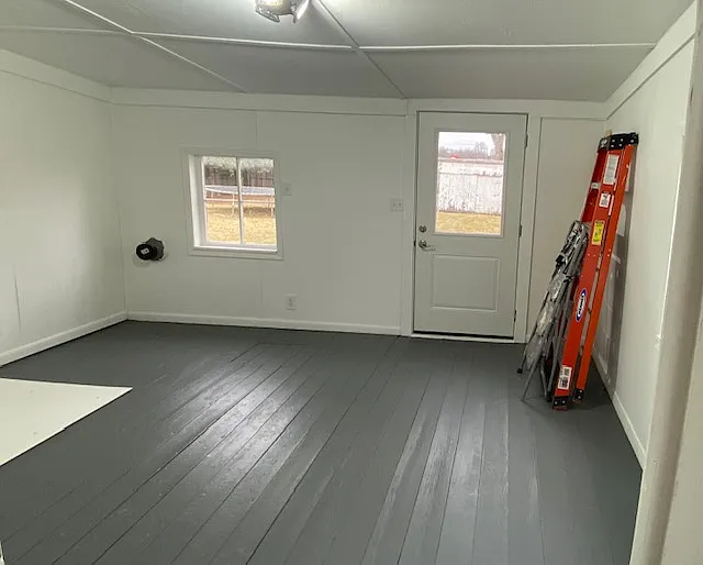 Spacious back porch leading to concrete patio and fenced back yard
