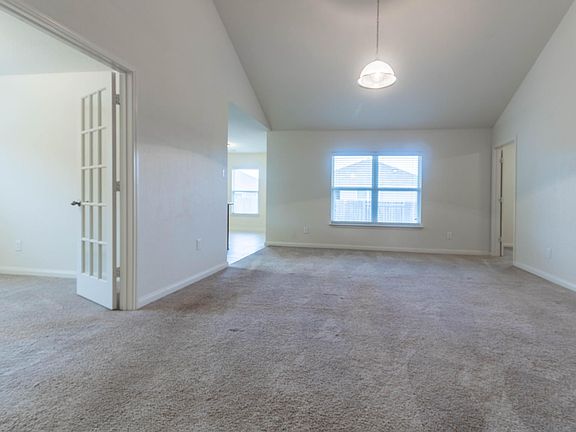 Living room with office/flex room with french doors
