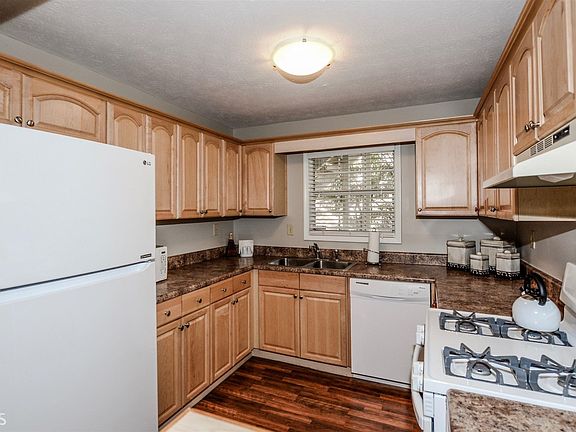 The spacious kitchen offers ample counter-top space and cabinet storage and is open to the dining ar