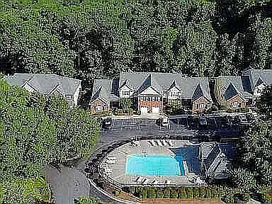 Skyview of pool & rental property - the 2 story at right garage door.