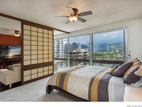 Spacious bedroom with sweeping view of the Ala Wai, mountains and golf course.