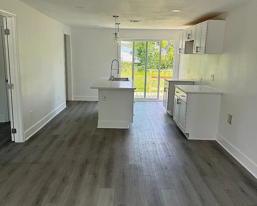 open layout, natural light, recessed lighting, pendant lights at island bar