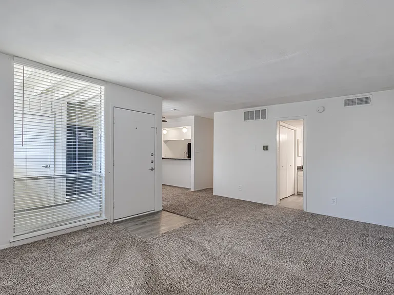 Bright living room with plush carpet and patio access
